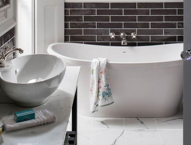 Lifestyle image of a boat bath with a seemingly paint splattered towel draped over its rim